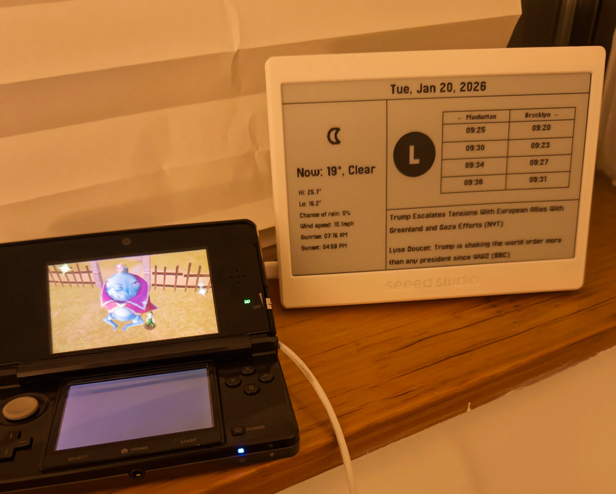 A picture of my epaper-dashboard next to a 3DS showing the Ocarina of Time end credits